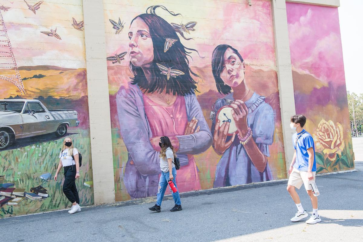 students in front of mural