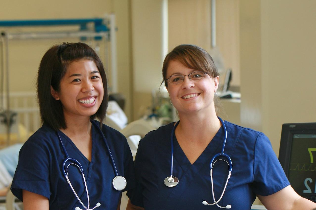 Two nursing students pose side by side