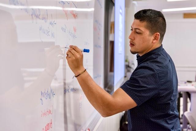 Professor writing on the whiteboard